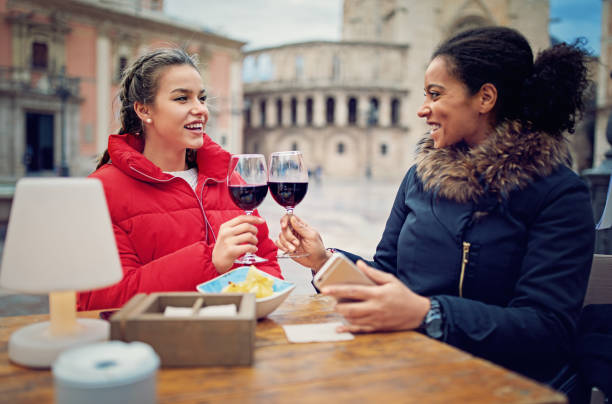 istock Best girlfriends are cheering with wine glasses in the restaurant 890395592