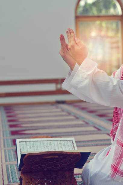 istock Hand of muslim people praying with mosque interior background 890395884