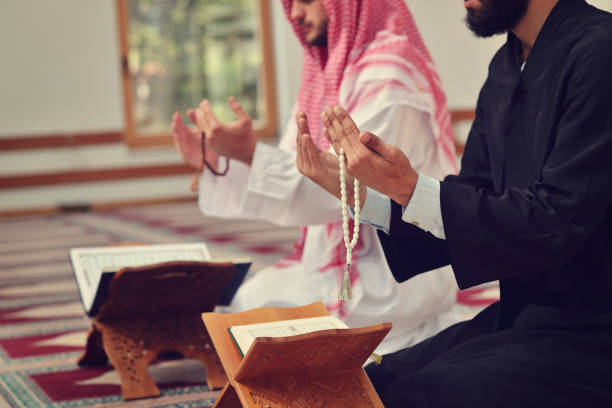 istock Two religious muslim man praying together inside the mosque 890402518