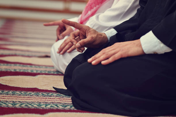 istock Two religious muslim man praying together inside the mosque 890404734