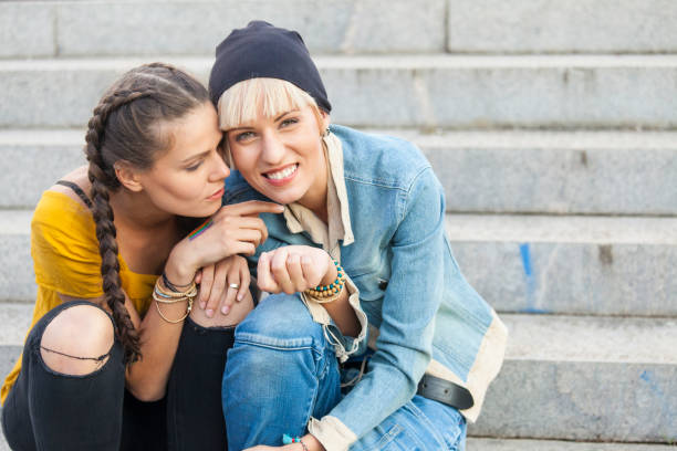 istock Two girls sitting on stairs 890407544