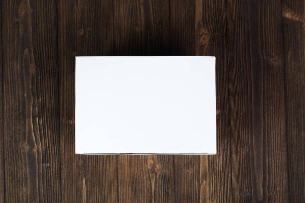 istock Empty white gift box or tray for mock up on dark wooden table with copy space. 890408246