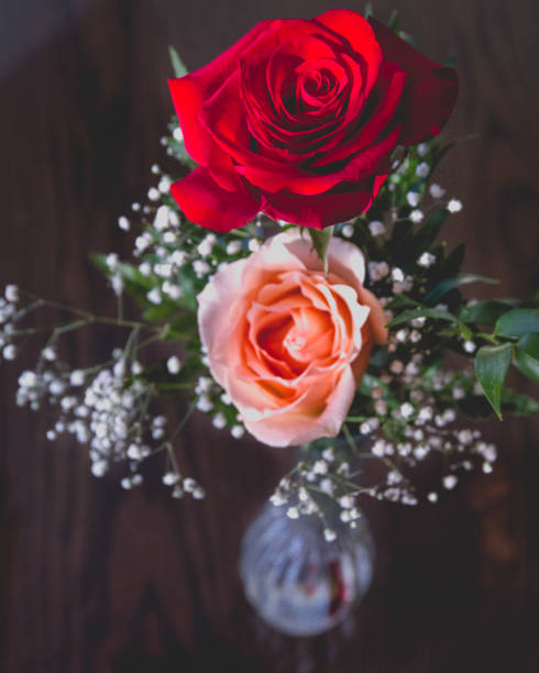 istock top view of peach and red rose on black background isolated 890412664