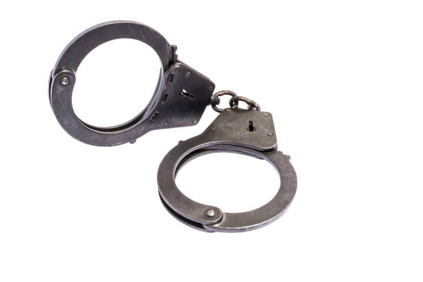 istock black metal handcuffs with small scratches on white background 890417872