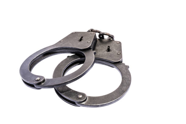 istock black metal handcuffs with small scratches on white background 890417876