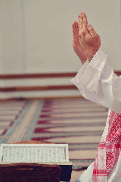 istock Hand of muslim people praying with mosque interior background 890417998
