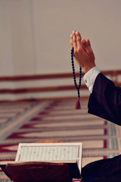 istock Hand of muslim people praying with mosque interior background 890423456