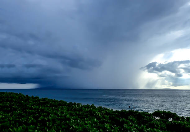 istock Huge Storm Clouds and Rain Over Island 890424080