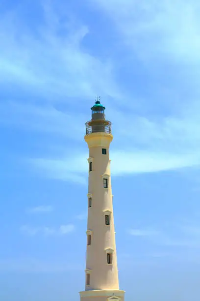 Photo of California Lighthouse on blue sky background isolated, Aruba coastline