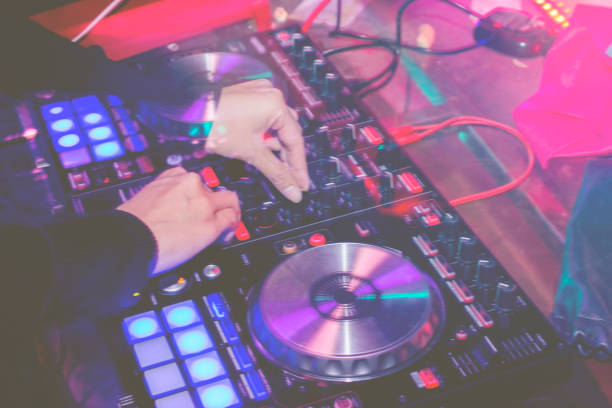 istock DJs are turntablism turntables plate mixer night party pub Motion blur wite light sunset  abstract background. 890434272