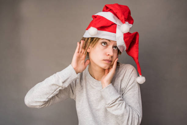 istock christmas young woman listening 890439266