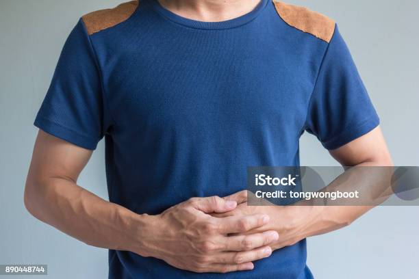 Man Have Stomachache On Gray Background Stock Photo - Download Image Now - Gastroesophageal Reflux Disease, Abdomen, Acid
