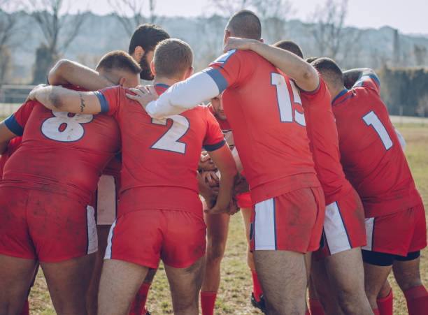 istock Group of rugby players huddling during time out 890448778