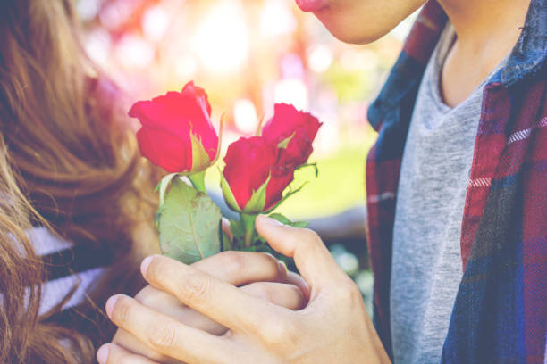 istock Men give women rose on Valentine's day. 890458886