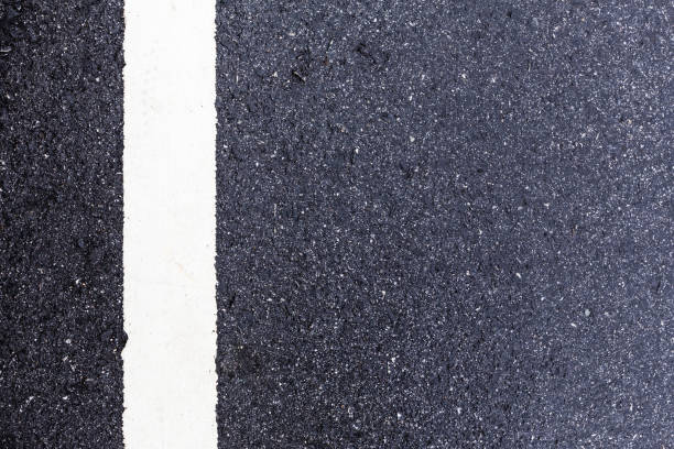 istock Asphalt road background with traffic line-close up 890470358