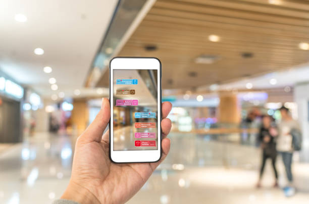 Augmented reality marketing in the shopping mall. Hand holding smart phone use AR application to check information Augmented reality marketing in the shopping mall. Hand holding smart phone use AR application to check information beacon photos stock pictures, royalty-free photos & images