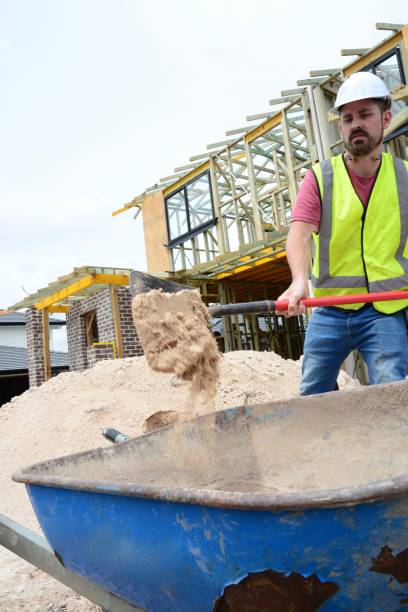 istock SYD112017 Construction worker and wheel barrow 890491796