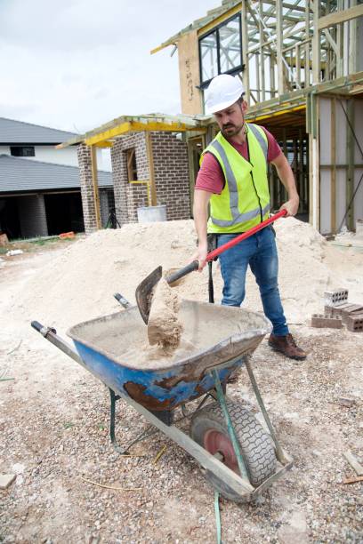 istock SYD112017 Construction worker and wheel barrow 890491826