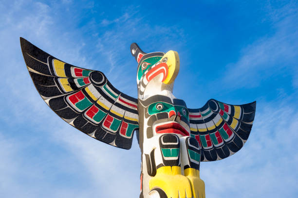 Ancient colorful Totem Pole in Duncan, British Columbia, Canada. View of ancient colorful Totem Pole with blue sky behind it in Duncan, British Columbia, Canada. duncan british columbia stock pictures, royalty-free photos & images
