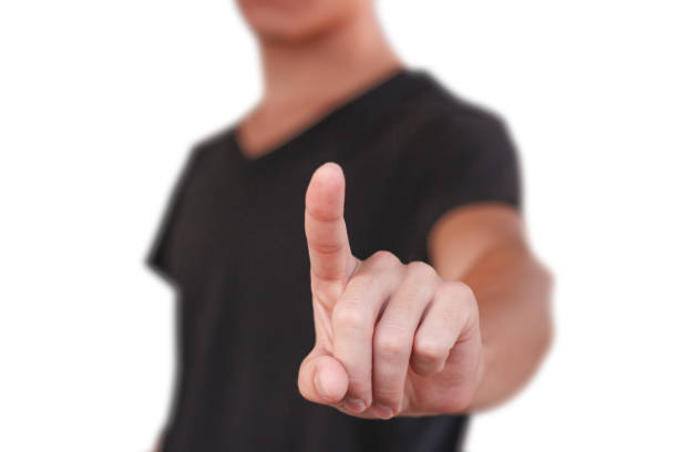 istock A young guy in a black t-shirt pressing on the screen. On grey background. 890545470