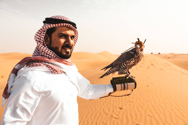 istock arabic man in the desert with a falcon 890568980