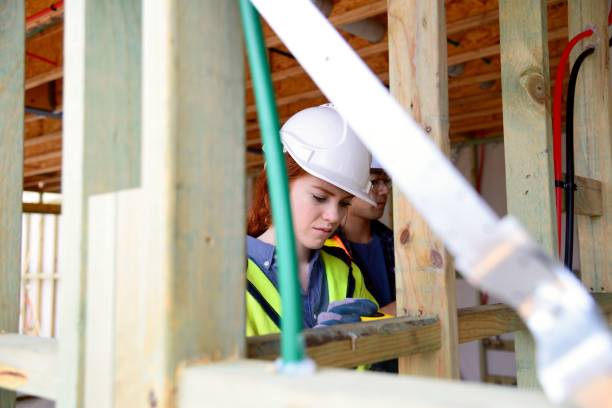 istock SYD112017 Female construction worker working doing measurement 890575578