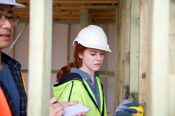 istock SYD112017 Female construction worker working doing measurement 890576514