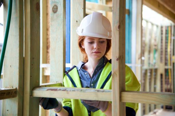 istock SYD112017 Female construction worker working doing measurement 890578418