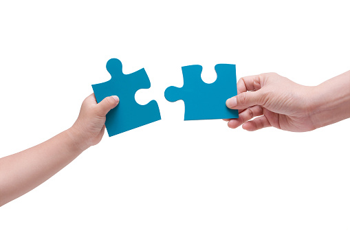 (clipping path) Two Puzzle Pieces Coming Together isolated on white background