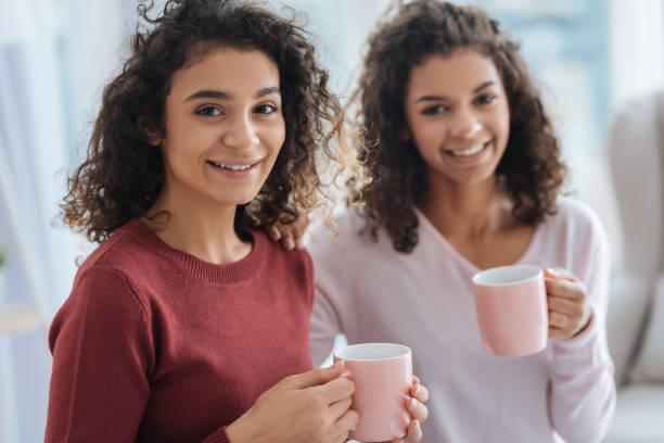 istock Cheerful young ladies relaxing and enjoying aromatic tea 890589452