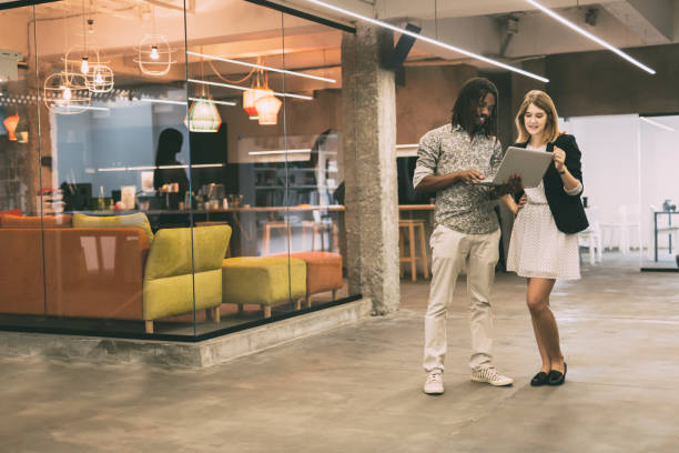 istock Coworkers talking in a modern office 890589524