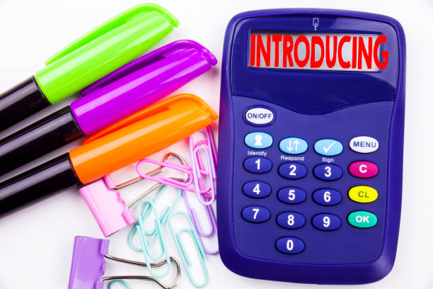 istock Writing word Introducing text in the office with surroundings such as marker, pen writing on calculator. Business concept for Introduction Start Intro Beginning white background with copy space 890590194