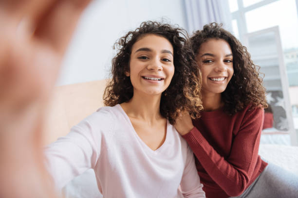 istock Loving siblings taking selfies at home 890590412