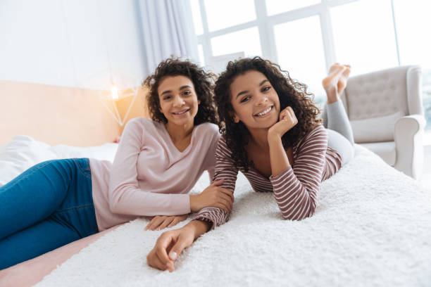 istock Extremely happy sisters enjoying free time at home 890592794
