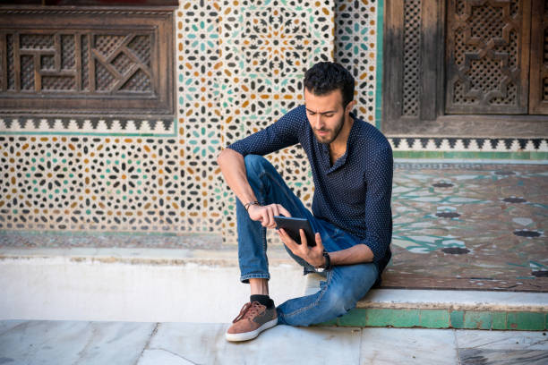 istock Young Arab man working on tablet in a traditional ambient 890597918