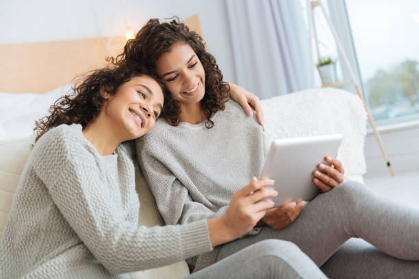 istock Loving young lady embracing her sister and smiling 890598130