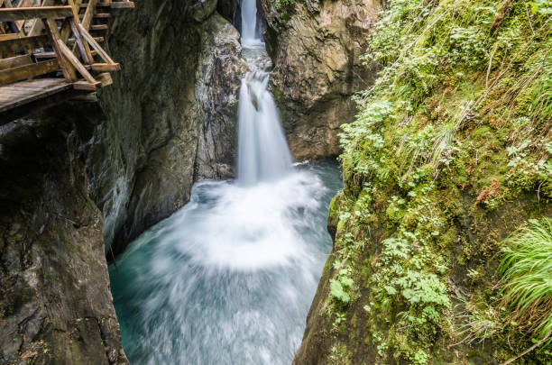 istock waterfall in ravine in the mountains 890617136
