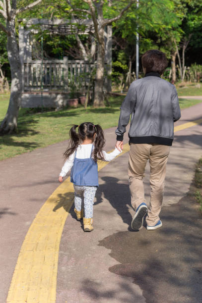 istock Father and girl playing in the park 890622114