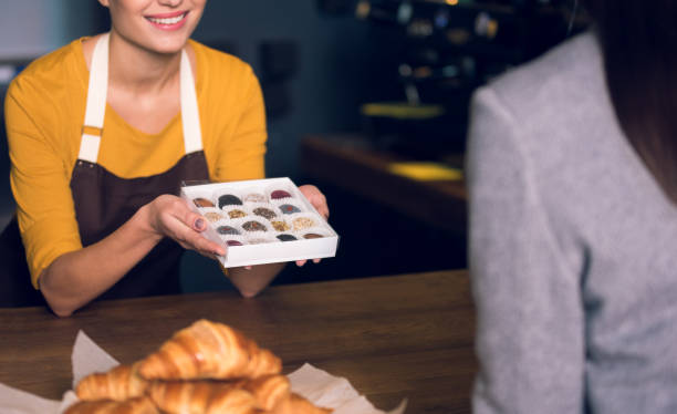 istock Female arms showing sweets to visitor 890632064