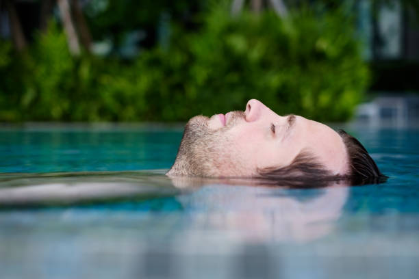 istock Content caucasian man in a swimming pool. 890632438