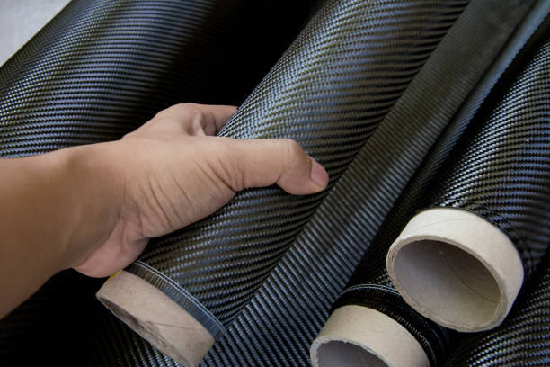 istock black carbon fiber composite raw material with hand 890632602