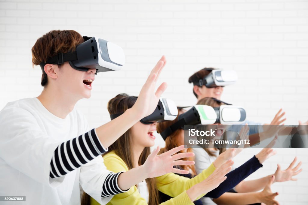 Young group having fun with new technology vr headset Child Stock Photo