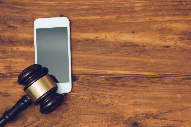 istock Judge gavel over smartphone, top view 890637980