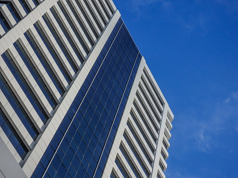 Low angle angular view of a corporate building against a blue sky
