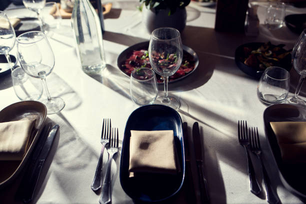 istock service with silverware and glass stemware for an event party 890647154