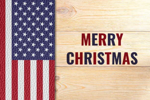 Merry Christmas, greeting card with us flag on wooden table