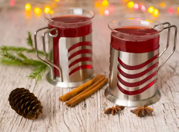 mulled wine with spices, fir branch, cone and xmas lights