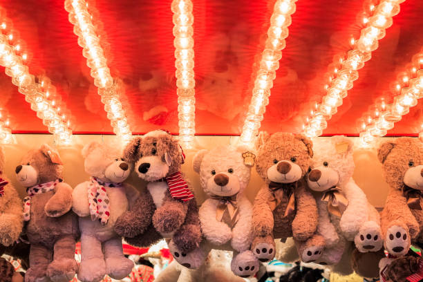 Stuffed toy bears on display awarded as winning prizes at Christmas funfair Stuffed toy bears on display awarded as winning prizes at Christmas funfair winter wonderland stuffed toy stock pictures, royalty-free photos & images