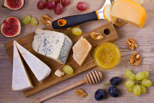 istock Cheese selection on wooden rustic background. Cheese platter with different cheeses 890653476