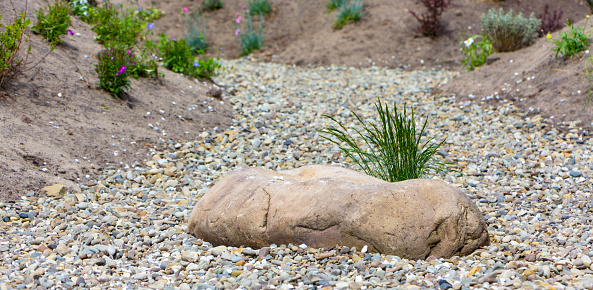 The use of marble chips and boulders in the creation of the Japanese garden of stones .